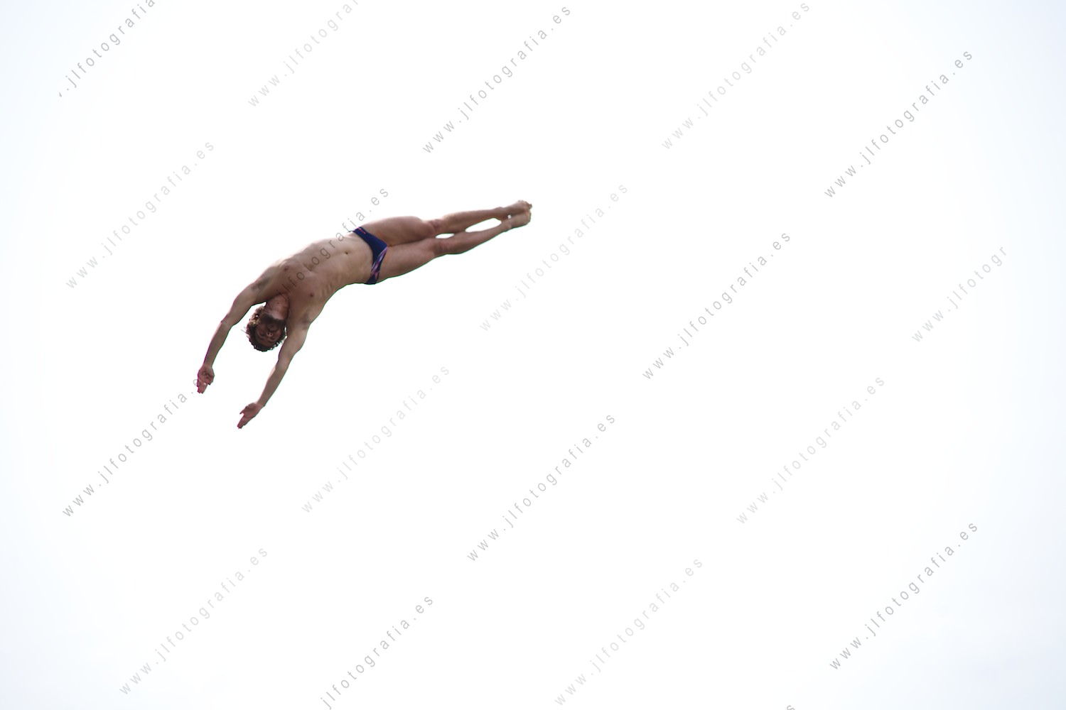 fotografía de detalle del cuerpo de un clavadista de en el Red Bull Cliff Diving sobre el cielo de Bilbao