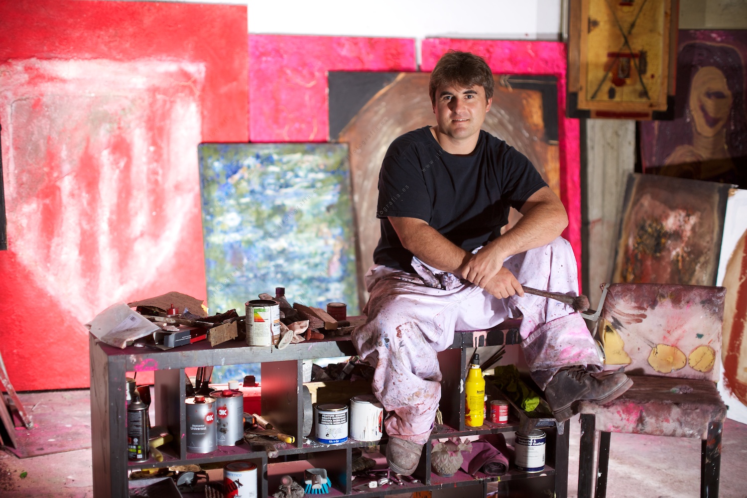 Retrato del artista de Barakaldo Jokin Burgo, sentado en su estudio con algunas de sus obras